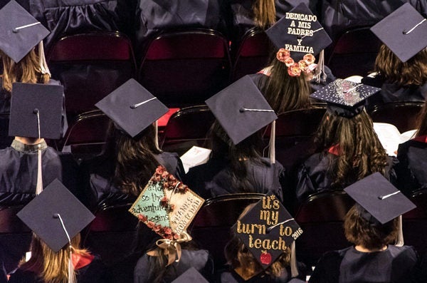 Students in dark caps and gowns