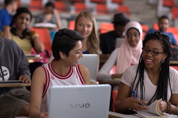 Students in class looking at laptop