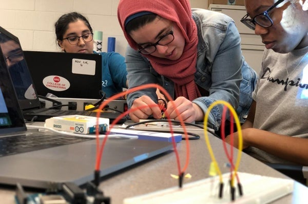 Female students working on engineering project.