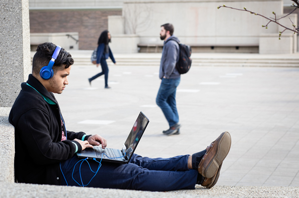 Student with laptop on campus